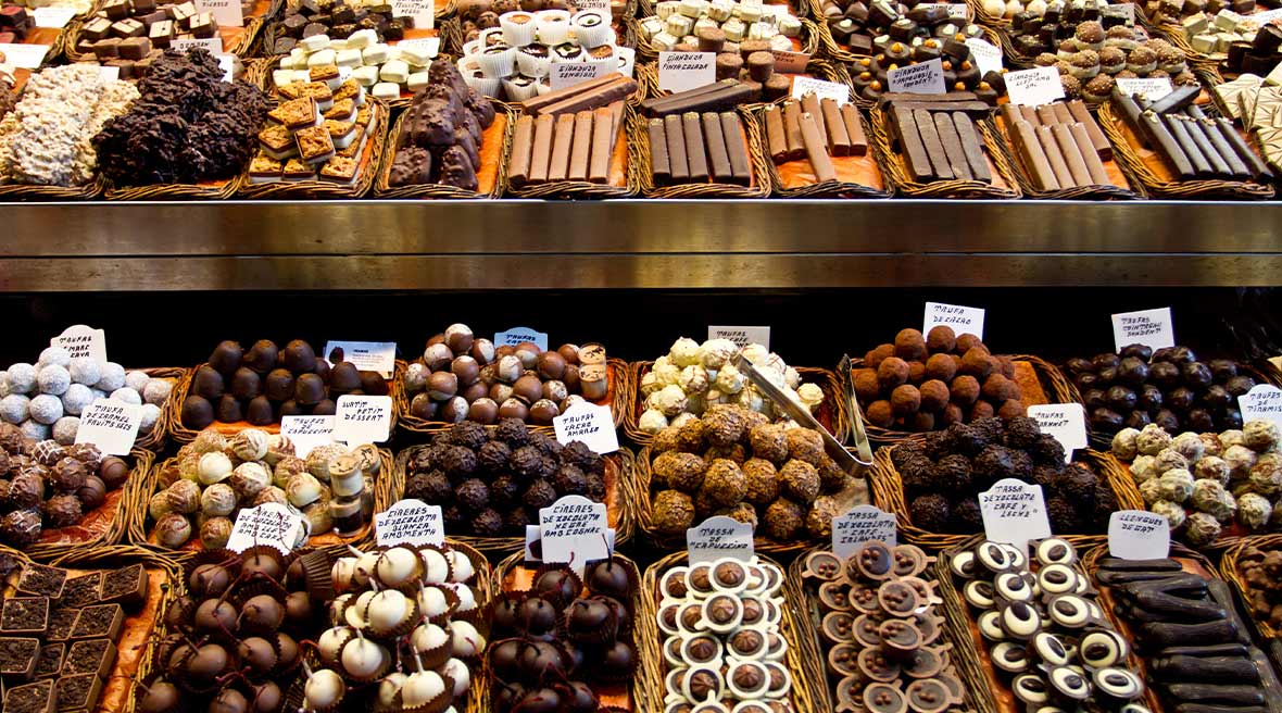 rows and rows of different chocolates in various shapes and sizes with little signs for price and flavour